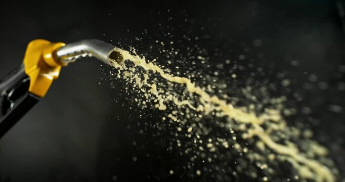 Super slow motion (1000 fps) fuel vapors escaping from gasoline nozzle, symbol of evaporation, depletion and fuel shortage. Minimal emissions on dark background, energy crisis concept.