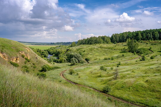 Dirt road winds between the hills near Ishutinskaya Mountain, Tula region of Russia