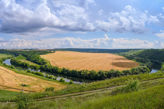 Rural landscape with a field and the Krasivaya Mecha River near the village of Shilovo, Tula region of Russia