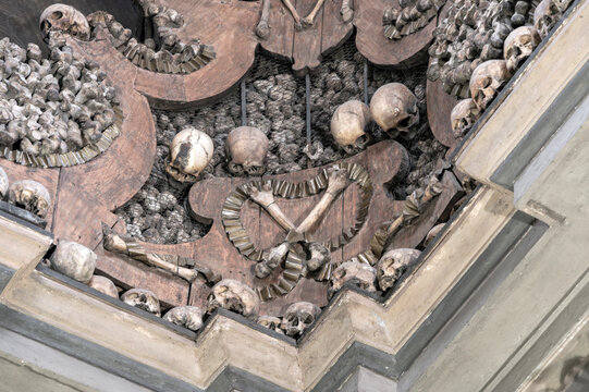 Human skulls and bones arranged as decorative memento mori inside the ossuary chapel of San Bernardino alle Ossa in Milan, Italy