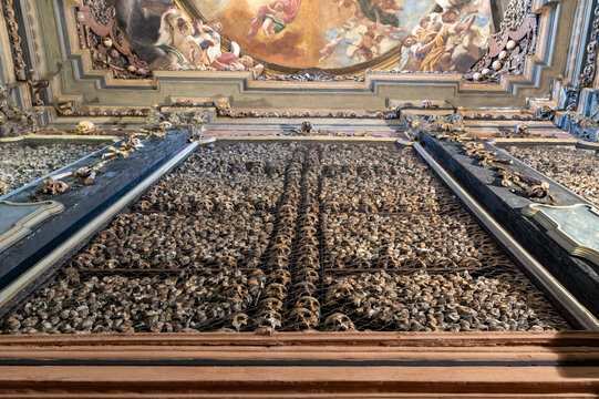 Skulls of executed prisoners displayed among human bones in the ossuary of San Bernardino alle Ossa in Milan, Italy