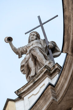Allegorical statue of Faith holding a cross on the facade of San Francesco di Paola Church in Via Manzoni, Milan, Italy