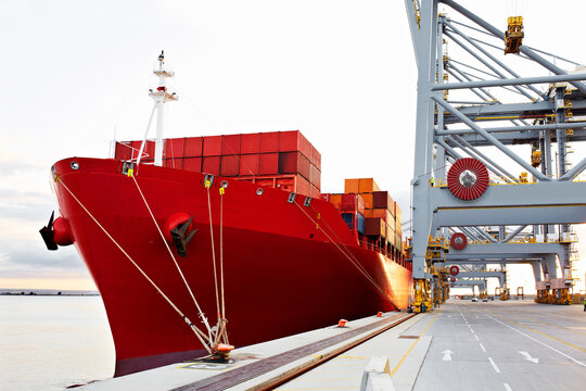 Boat, cargo and maritime shipping with dock for supply chain, export and global distribution. Transport, container and commercial port for logistics, freight and delivery for international courier