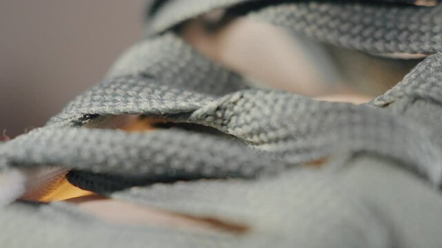 Closeup of textured shoelaces. Highresolution image highlighting detailed craftsmanship of shoelace weaving and stitching