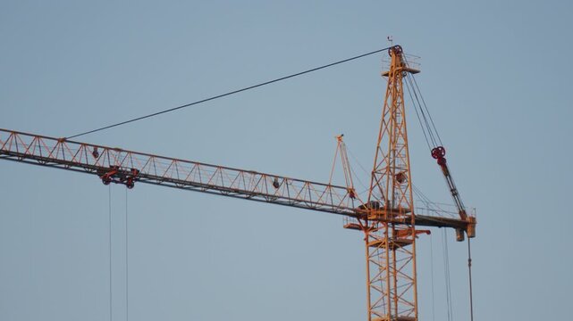 Yellow tower cranes at a construction site of a modern building