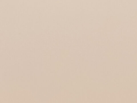 Seamless high-resolution nude beige matte surface texture background with subtle fine paper grain. Ideal target for cosmetic product mockups, beauty branding backdrops, minimalist graphic design