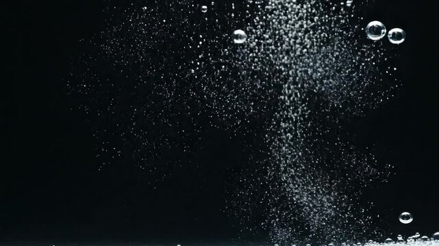Bubbles ascend through dark liquid creates an abstract and serene scene