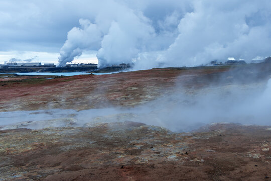 On the Reykjanes Peninsula, Iceland, Gunnuhver geothermal field spreads dense vapor above mineral-stained ground. Active steam beside rough brown and grey geothermal earth appears.