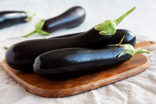 Raw Organic Eggplant on a Wooden Board
