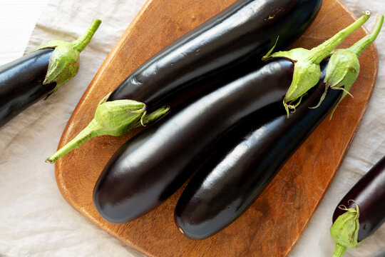 Raw Organic Eggplant on a Wooden Board