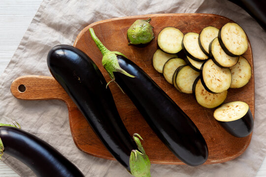 Raw Organic Eggplant on a Wooden Board
