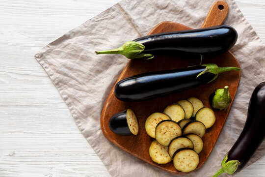 Raw Organic Eggplant on a Wooden Board