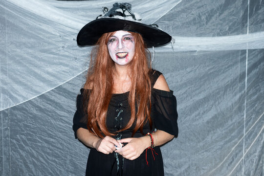 Smiling woman dressed as a witch at Halloween party