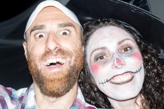 Friends posing in spooky costumes at Halloween party