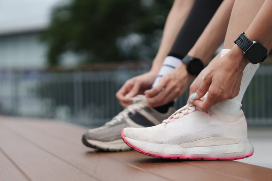 Close up of runner tying shoe laces before outdoor workout