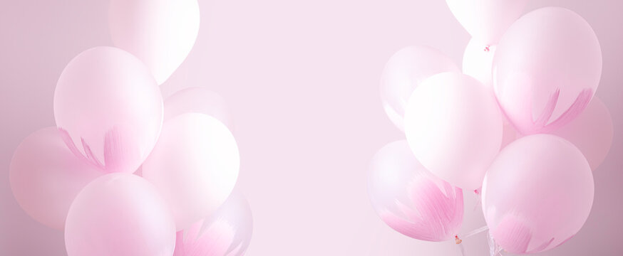 Pink birthday balloons with gentle patterns as festive celebration background and free space in center