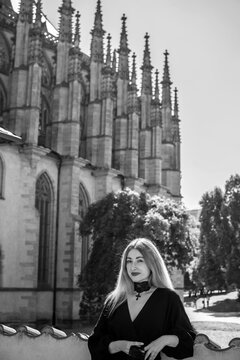 Woman exploring historic streets of Kutna Hora with St. Barbara Cathedral in background, Czech Republic travel concept