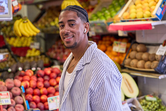 Young man smiling at fresh fruit market