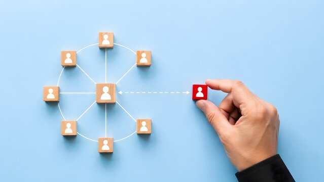 Hand connecting wooden blocks with human icons in network structure representing human resources recruitment and team building