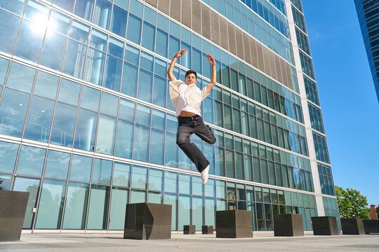 Young man jumping with joy in urban setting