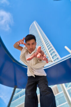 Young man reaching out in urban environment