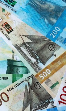 Norwegian krone money bills in pile on table. Norway NOK currency cash close up