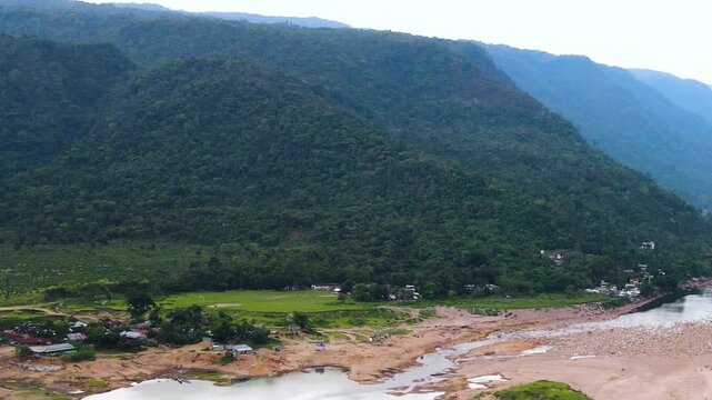 Beautiful hill Valley with dry riverbed and hillside village at bichanakandi, Sylhet, Bangladesh india border - aerial.