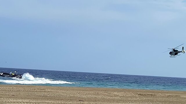 Civil Guard helicopter pursuing a drug traffickers' boat. Inflatable boat attempting to evade police interception. Spain.