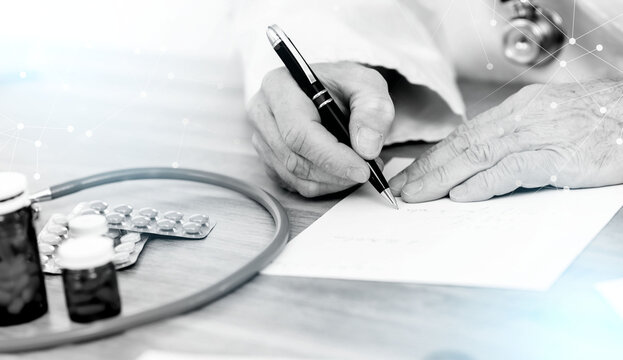 Doctor writing a medical prescription; light effect