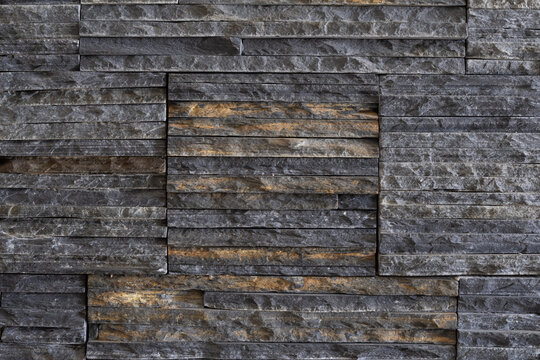 Textured decorative stone cladding made of narrow stacked pieces for modern wall finishing and interior design
