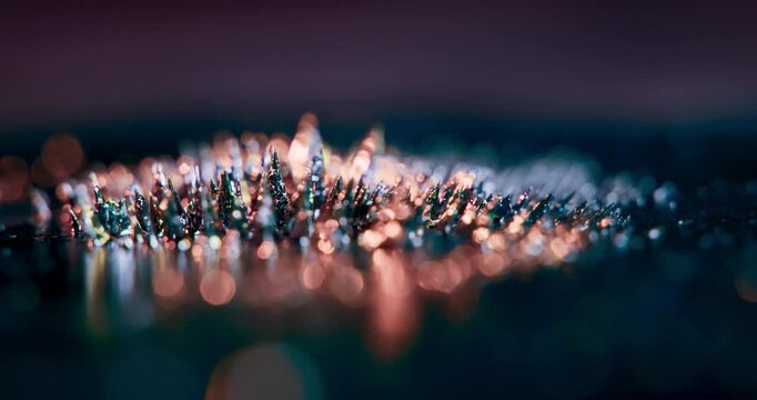 This closeup image of metal particles reacting to magnetism against a black background is perfect for motion graphics and abstract design effects that captivate and evoke viewer interest