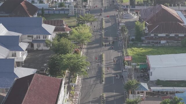 A view of Gorontalo City on the weekend, featuring the cityscape and runners during Car Free Day.