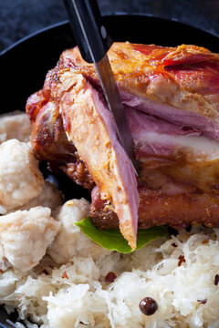 Sliced knuckle of pork with bread dumplings and Sauerkraut, close-up