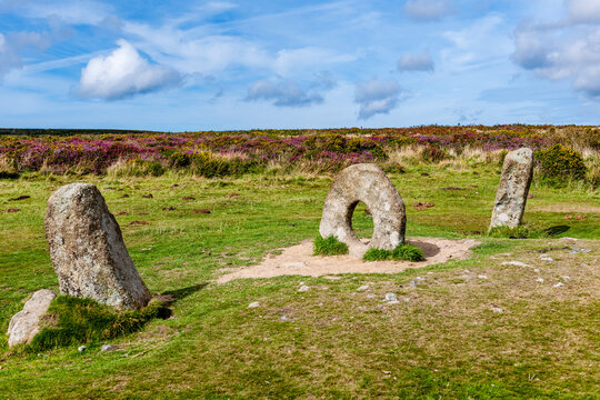 The ancient Men an Tol megalith stands in a rural Cornwall landscape