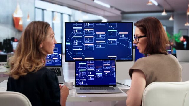 Young Woman Uses Laptop To Build Workflow Automation