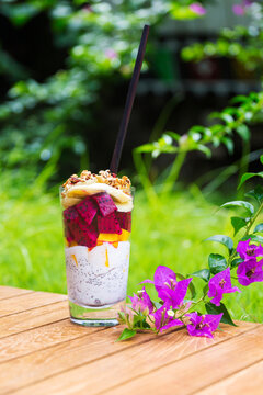 Glass of chia pudding with different fruits and cereals