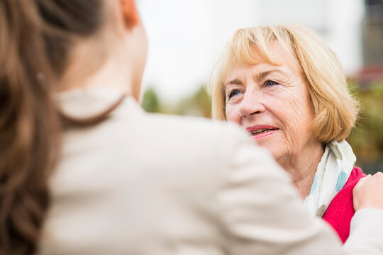 Portrait of blond senior woman communicating with her granddaughter