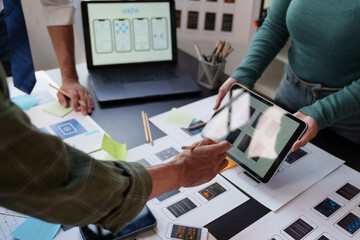 UX and UI designers collaborating on mobile application development, brainstorming user experience...