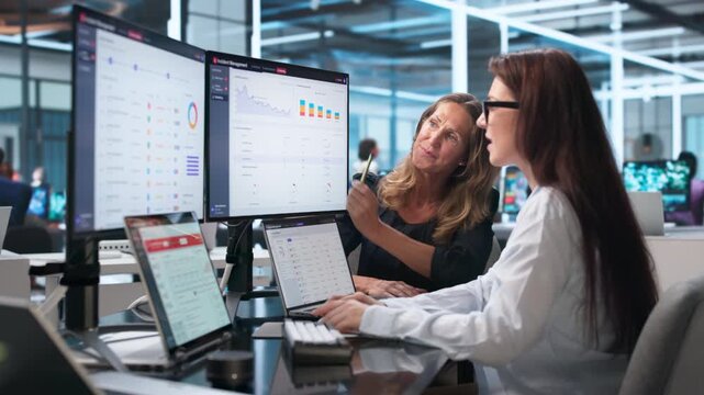 Woman Using Laptop To Monitor Alerts