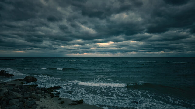 Dark stormy sea rocky shore panorama