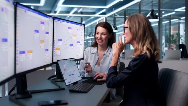 Woman Showing Manager How To Use New Software