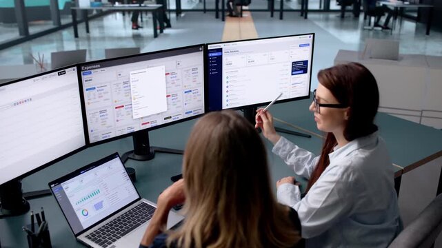Woman Reviews Year-end Financial Reports Using Laptop