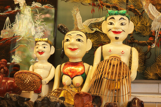 Vietnamese water puppets wooden characters, traditional lacquered wood dolls representing folklore culture for tourist souvenir market, Vietnam