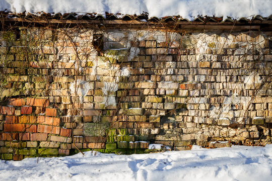 Old abandoned brick wall in winter. Architectural detail.
