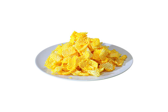Crunchy yellow potato lattice chips served on white plate isolated on transparent background