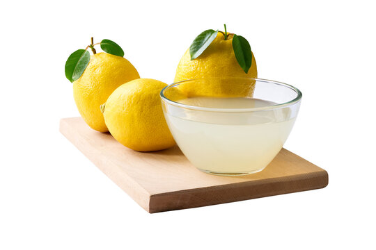 Ripe lemons fruit and bowl of lemon juice isolated on white background. freshly squeezed lemon juice .