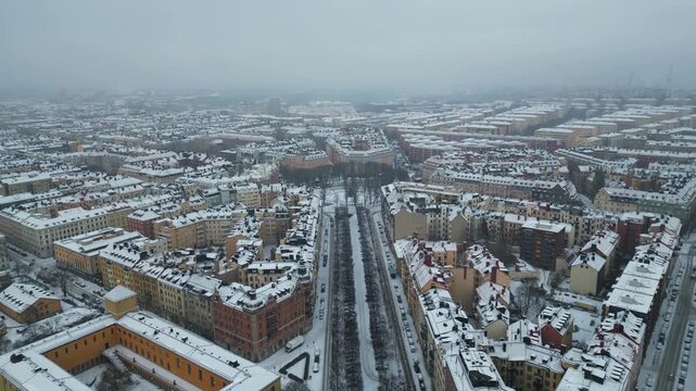 Drone Shot of Stockholm Sweden on Cold Winter Day, Snow Capped Streets and Buildings Around Karlaplan Park