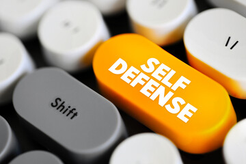 Naklejka premium Self Defense is a countermeasure that involves defending the health and well-being of oneself from harm, text concept button on keyboard
