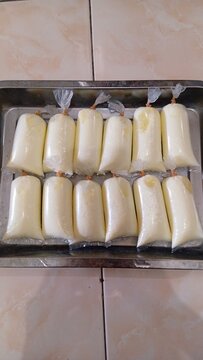 Vertical Top View of Cooked Steamed Egg Whites Packaged in Plastic Bags on Metal Tray