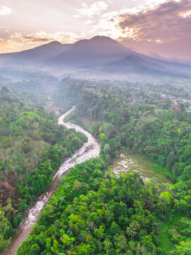 the beauty of the foggy morning panorama with sunrise and rice fields in Bengkulu, indonesia, asia